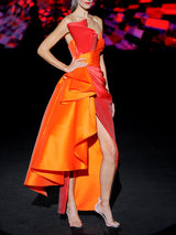 Vestido de fiesta midi en mikado color teja y naranja, cuerpo escote corazon drapeado tableado y decorado con un capote, falda sirena cruzada terminando en un capote XL en color naranja de HANNIBAL LAGUNA.