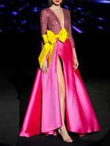 Vestido de fiesta largo en mikado pique fresa y lentejuelas granate, t-shirt con escote V con manga larga y amplia falda de capa cruzada. Cinturón lazo en color lima de HANNIBAL LAGUNA.