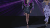 LOOK 35 JALAHA Bodysuit Blouse and JONI Skirt | Bodysuit blouse made of pleated gauze, cyclamen, amethyst, and black. Mini skirt made with boreal embroidery in navy blue