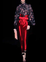 a man standing in front of a red light