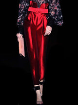 a close up of a person holding a red object