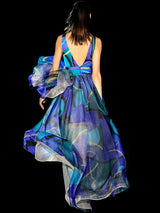 a woman in a blue dress holding a kite