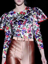 a woman in a polka dot dress holding a purse