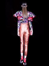 a woman walking down the street with a umbrella