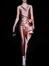 a woman in a pink dress holding a tennis racquet