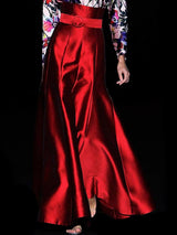 a close up of a person wearing a red dress