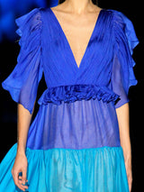 a woman wearing a blue dress and a blue dress
