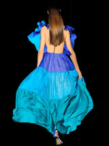 a woman in a blue dress on a cell phone