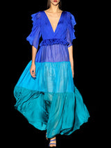 a woman in a blue dress holding a blue umbrella