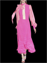 a woman in a pink dress holding a pink umbrella