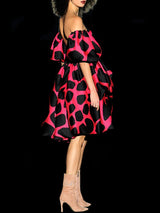 a woman in a red dress holding a cell phone