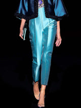 a couple of people walking down a sidewalk