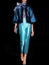 a couple of people walking down a street