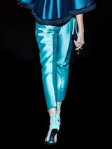 a man walking down a street holding a skateboard