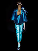 a man in a blue jacket talking on a cell phone