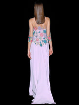 a woman in a pink dress holding a tennis racquet