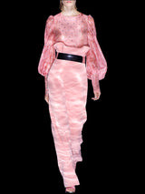 a woman in pink is holding a pink object