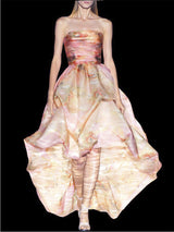 a woman in a pink dress holding an umbrella