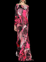 a woman in a pink dress holding a pink suitcase