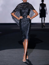 Vestido lápiz con escote palabra realizado en micro volantes de organza y amplia estola de Hannibal Laguna