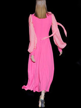 a girl in a pink dress holding a pink frisbee