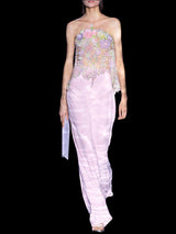 a woman in a pink dress holding a pink purse