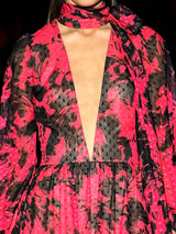 a woman in a red dress holding a cell phone