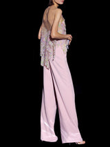 a woman in a pink dress holding a cell phone