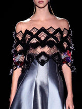 a woman in a dress holding a purse