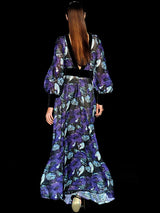 a woman in a purple dress holding a cell phone