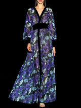 a woman in a purple dress holding a cell phone
