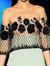 a woman in a dress holding a tennis racket