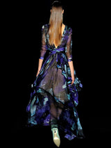 a person holding a skateboard in the dark