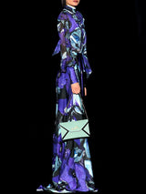 a person in a purple shirt is holding a skateboard