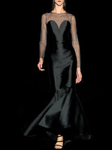 a man standing next to a woman in a dark suit