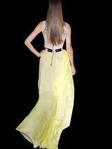 a woman in a white dress holding a umbrella