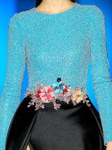 a woman in a blue dress holding a suitcase