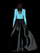 a woman in a black dress standing on a bench