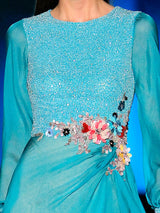 a woman in a blue dress holding a baseball bat