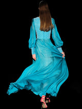 a woman in a blue dress is on a skateboard