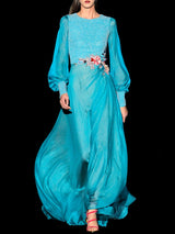 a woman wearing a blue jacket and a blue dress