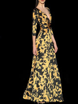 a woman standing in front of a tall tree