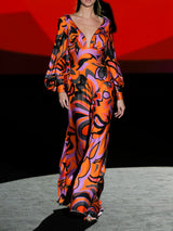 Vestido de noche satín estampado psicodélico naranja con escote en V, mangas XL, fajín con crepe planeado al bies y falda evasé de Hannibal Laguna