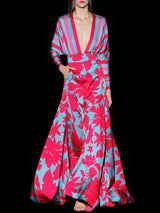 a woman in a red dress holding a cell phone