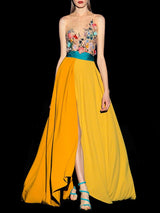 a woman in a yellow dress holding a yellow umbrella