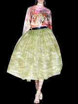 a woman in a dress holding an umbrella