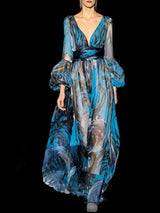 a woman in a blue dress holding a bag