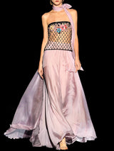 a woman in a pink dress holding a pink umbrella