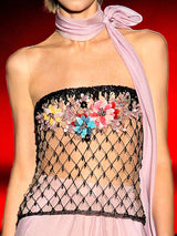 a woman in a bikini holding a tennis racquet