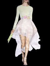 a woman in a white dress riding a white horse